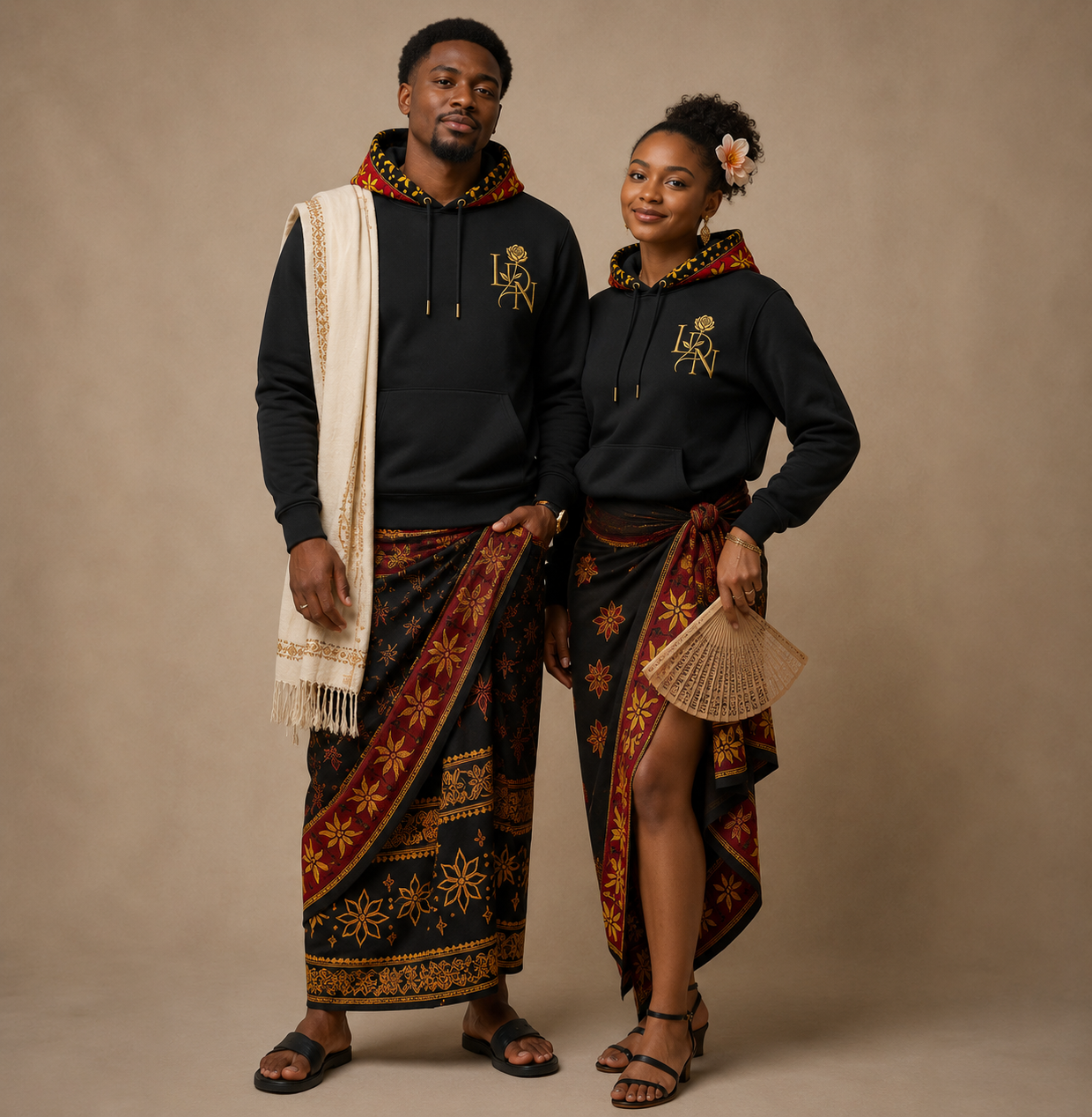 Couple portant les hoodies LDN au monogramme brodé d'or et des salouva traditionnels
